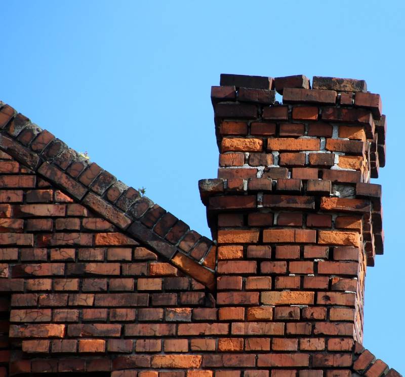 Signs Your Andover Home Needs a Chimney Inspection Blog Article - Damaged chimney on an Andover home showing cracks and missing mortar
